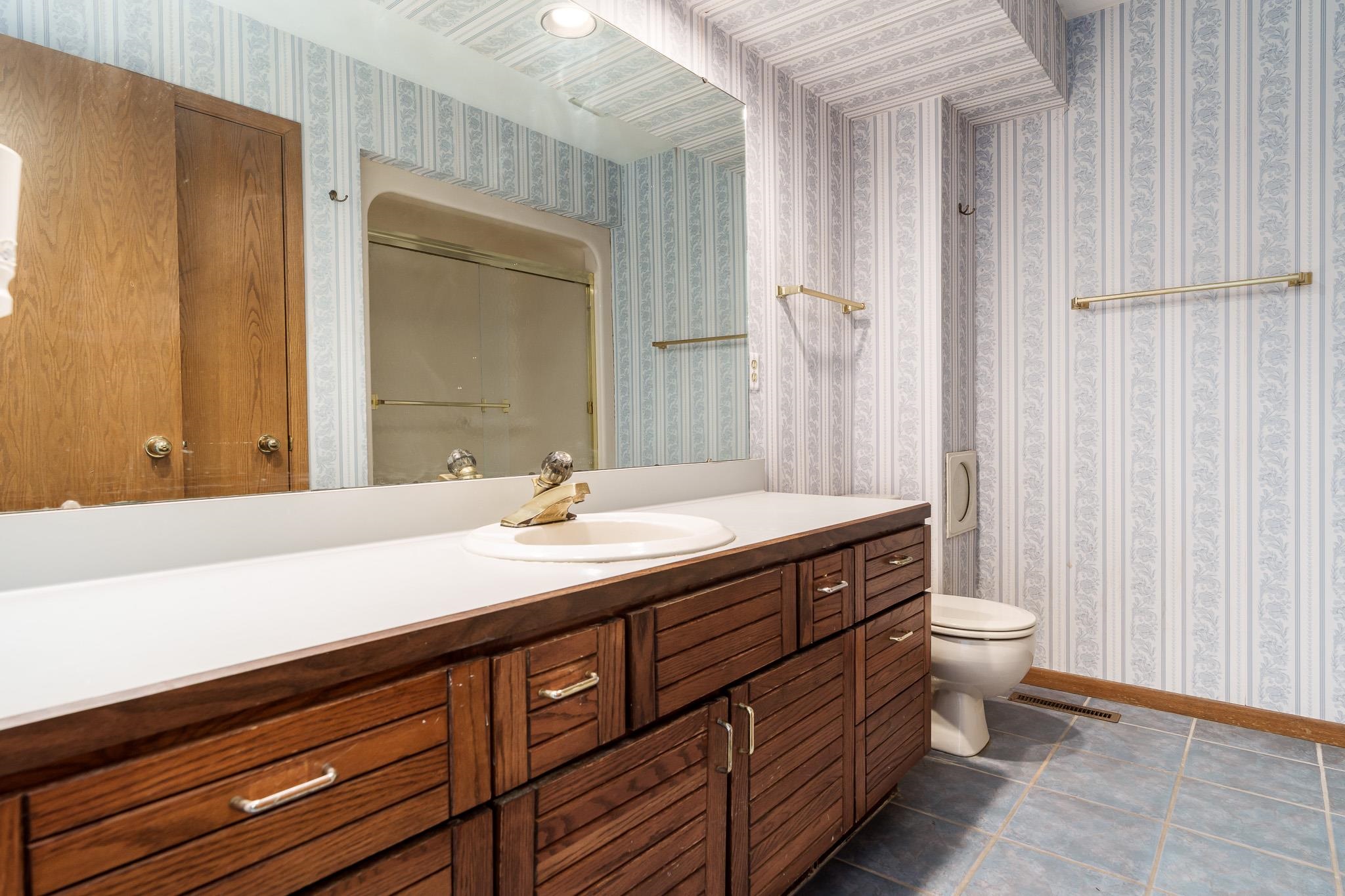 10245 Tybow Trail Roscoe, IL 61073 - Photo 44 of 63 a bathroom with a double vanity sink and a mirror