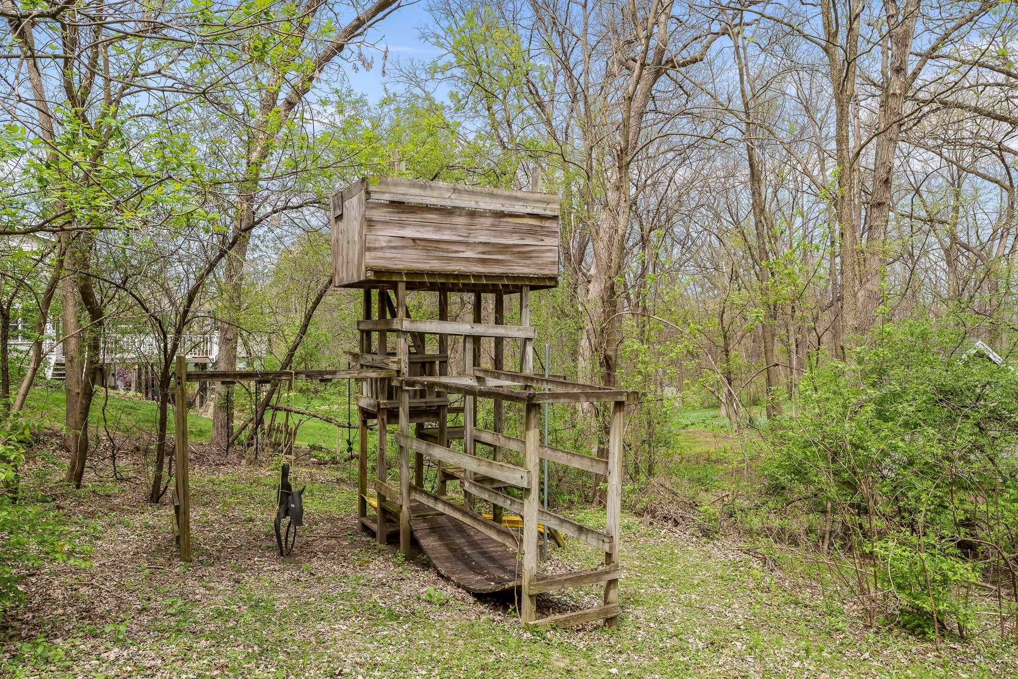 10245 Tybow Trail Roscoe, IL 61073 - Photo 61 of 63 a backyard of a house with lots of trees and entertaining space