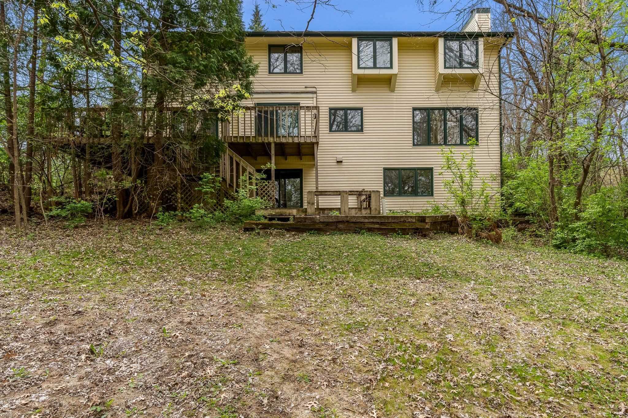 10245 Tybow Trail Roscoe, IL 61073 - Photo 63 of 63 a view of a brick house with large windows and a yard
