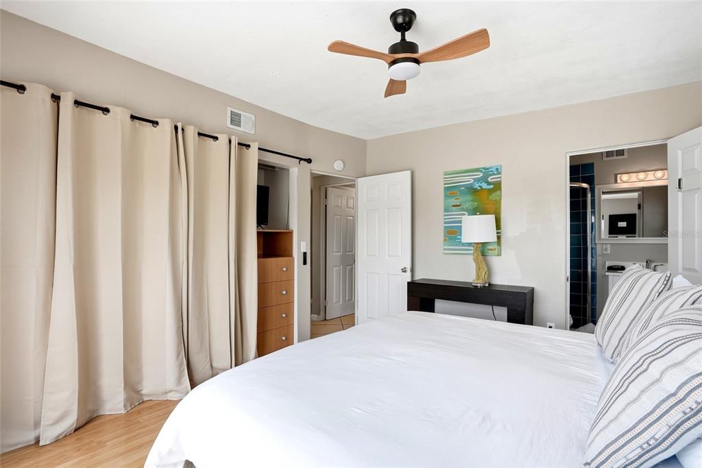 2311 Bay Boulevard Indian Rocks Beach, FL 33785 - Photo 52 of 80 a bedroom with a bed and a chandelier