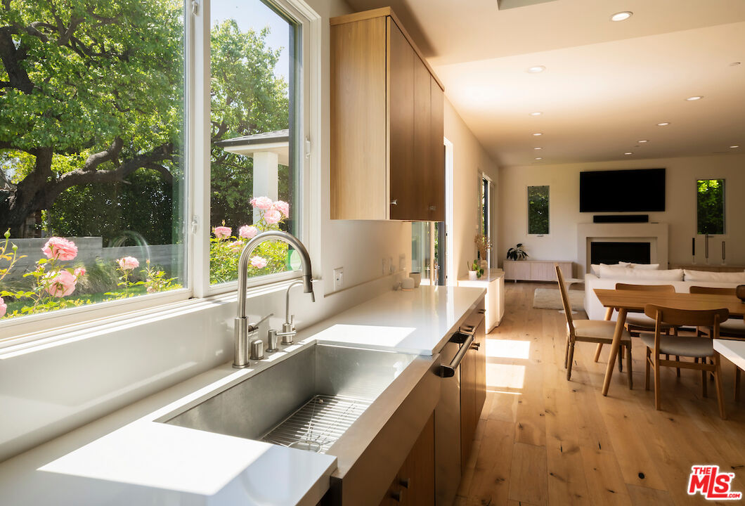 11328 Charnock Road Los Angeles, CA 90066 - Photo 16 of 34 a large kitchen with kitchen island a large window in it