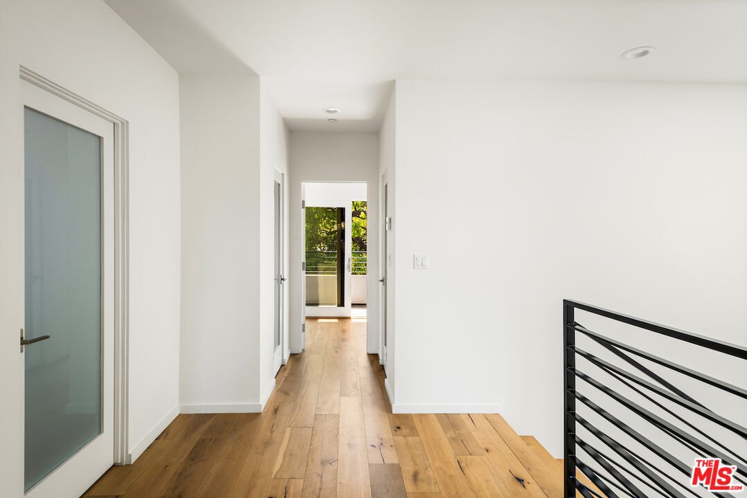 11328 Charnock Road Los Angeles, CA 90066 - Photo 22 of 34 a view of a hallway with wooden floor and staircase