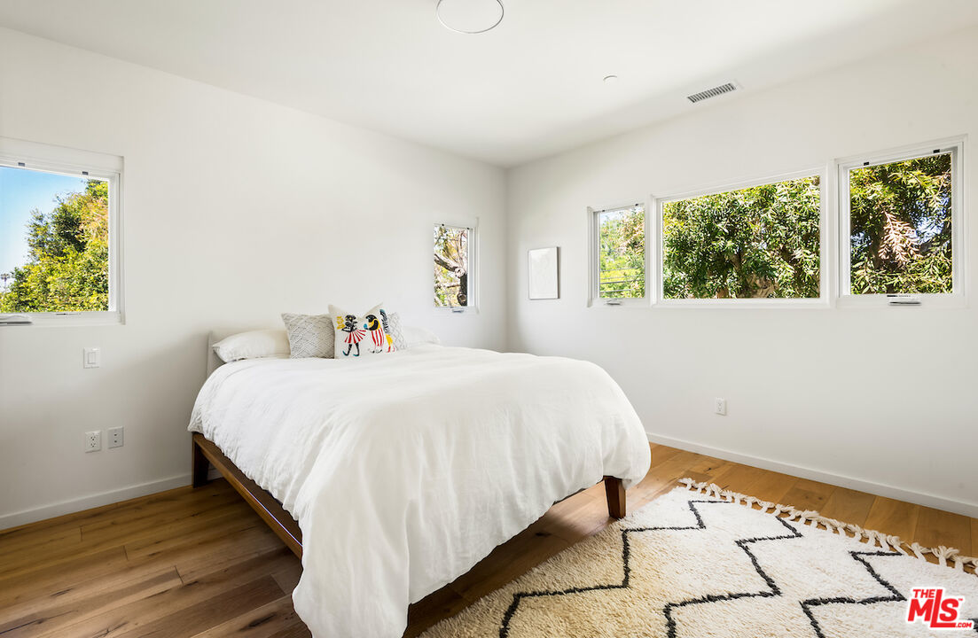 11328 Charnock Road Los Angeles, CA 90066 - Photo 26 of 34 a bed sitting in a bedroom next to a window