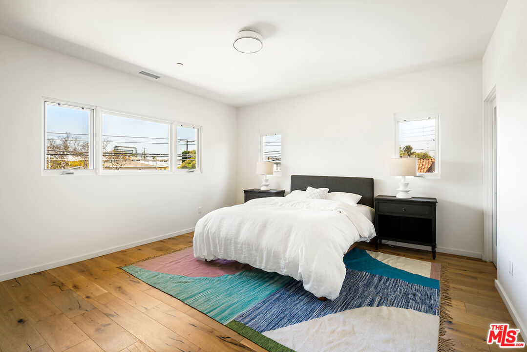 11328 Charnock Road Los Angeles, CA 90066 - Photo 28 of 34 a bedroom with a bed and wooden floor