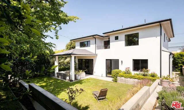 a view of house with swimming pool outdoor seating area and view of living room
