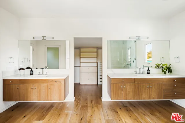 a spacious bathroom with a tub sink and mirror