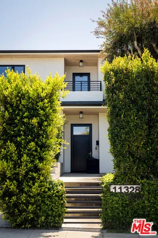 a front view of a house with a garden
