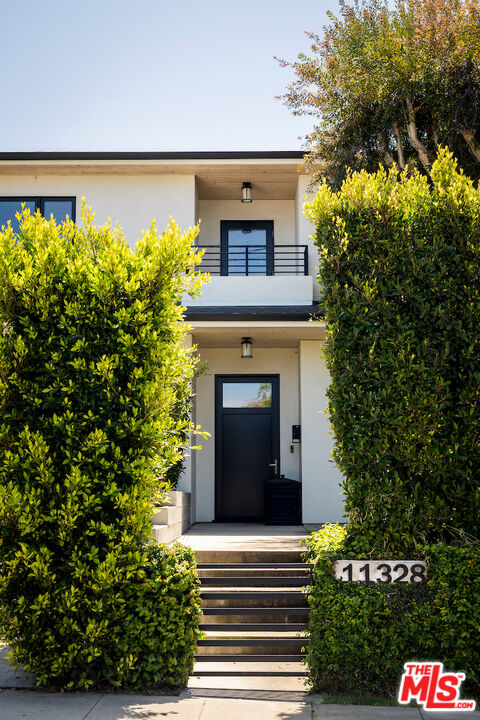 11328 Charnock Road Los Angeles, CA 90066 - Photo 7 of 34 a front view of a house with a garden