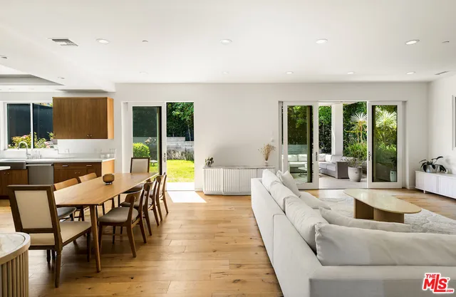 a large living room with furniture and large windows