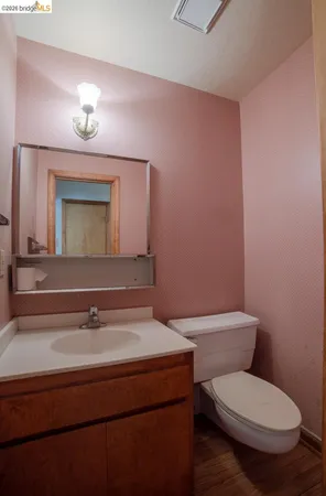 a bathroom with a toilet a sink and mirror