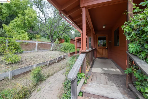 a backyard of a house with table and chairs