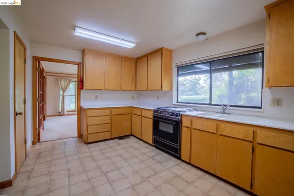 a kitchen with stainless steel appliances granite countertop a sink and cabinets