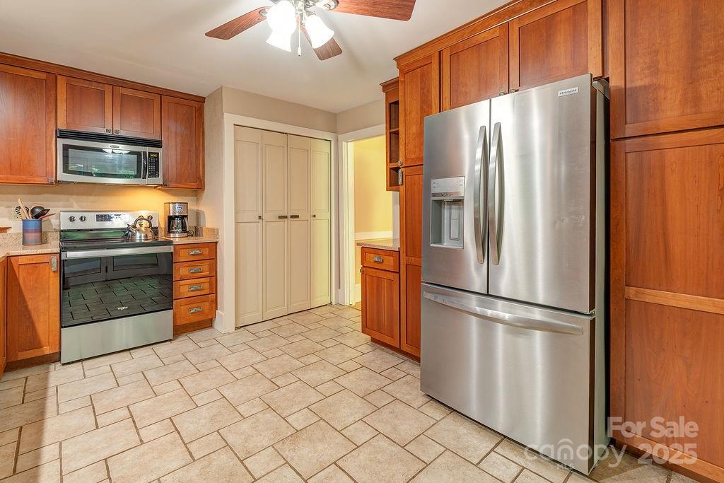 54 Spooks Branch Road Asheville, NC 28804 - Photo 11 of 41 a kitchen with stainless steel appliances granite countertop a refrigerator sink and cabinets
