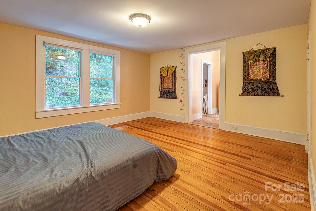 54 Spooks Branch Road Asheville, NC 28804 - Photo 18 of 41 a bedroom with a bed and a window