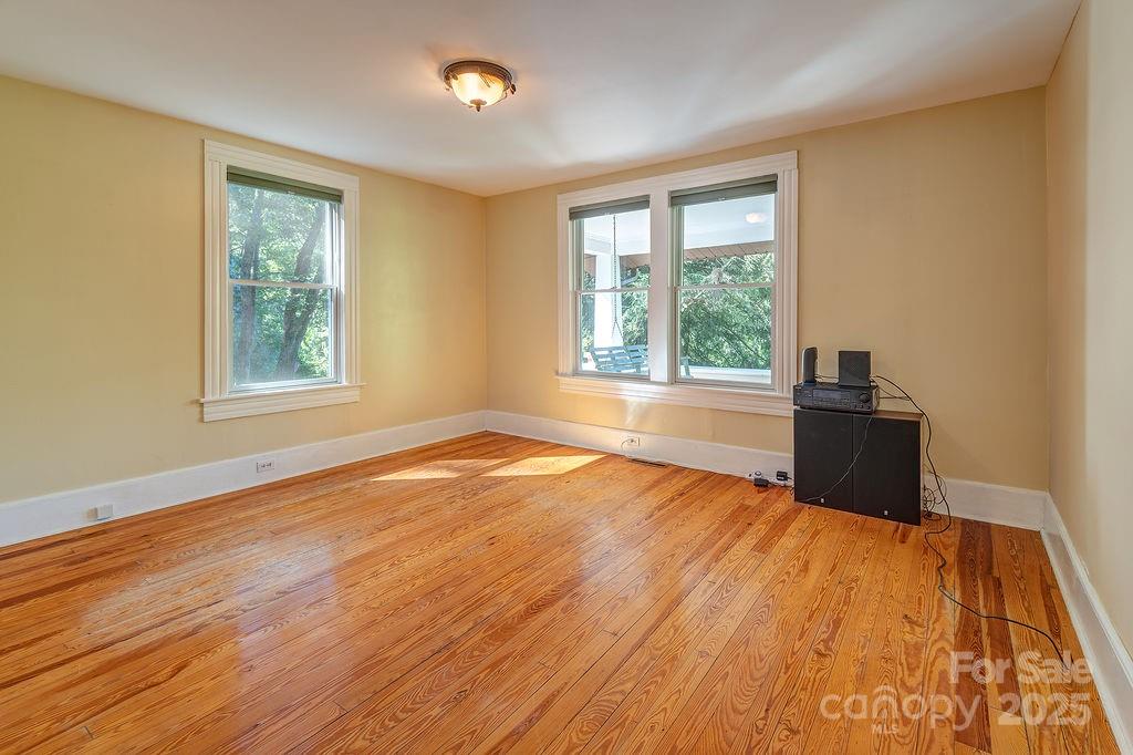 54 Spooks Branch Road Asheville, NC 28804 - Photo 20 of 41 a view of a room with wooden floor and windows