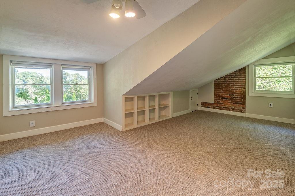 54 Spooks Branch Road Asheville, NC 28804 - Photo 24 of 41 an empty room with a fireplace and window
