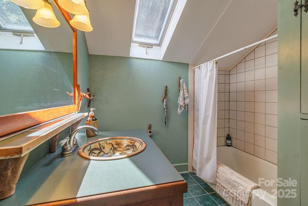 54 Spooks Branch Road Asheville, NC 28804 - Photo 25 of 41 a bathroom with a sink and a shower