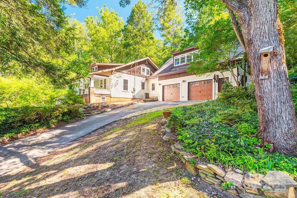 54 Spooks Branch Road Asheville, NC 28804 - Photo 27 of 41 a front view of a house with a yard and a garden