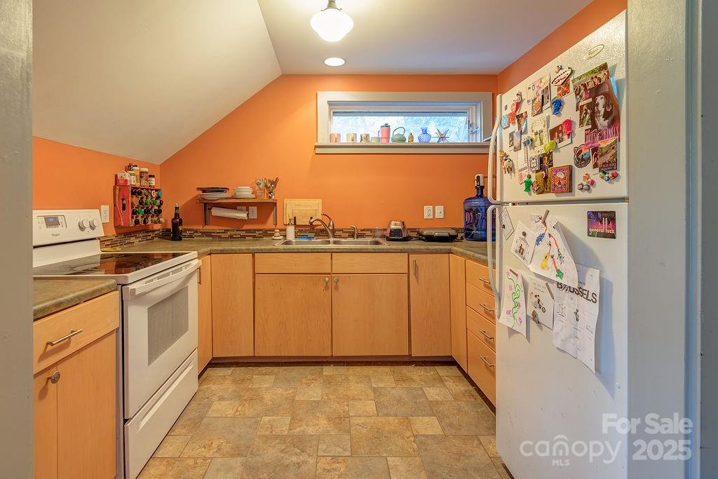 54 Spooks Branch Road Asheville, NC 28804 - Photo 31 of 41 a kitchen with stainless steel appliances granite countertop a stove a sink and a microwave
