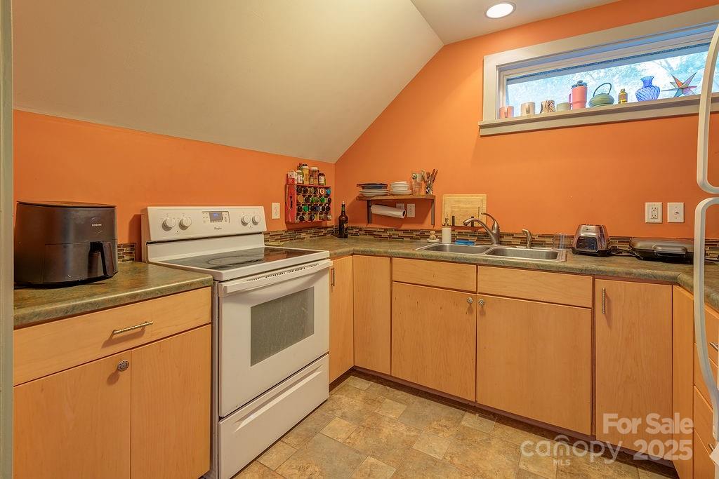 54 Spooks Branch Road Asheville, NC 28804 - Photo 32 of 41 a kitchen with stainless steel appliances granite countertop a stove a sink and a microwave