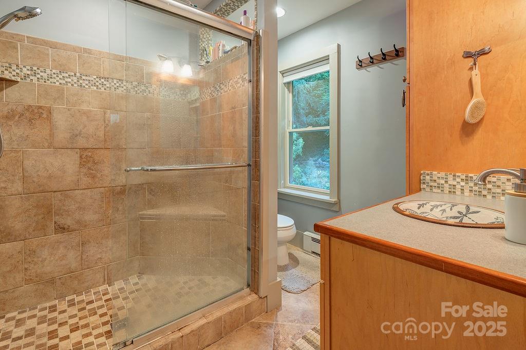 54 Spooks Branch Road Asheville, NC 28804 - Photo 33 of 41 a bathroom with a sink toilet and shower