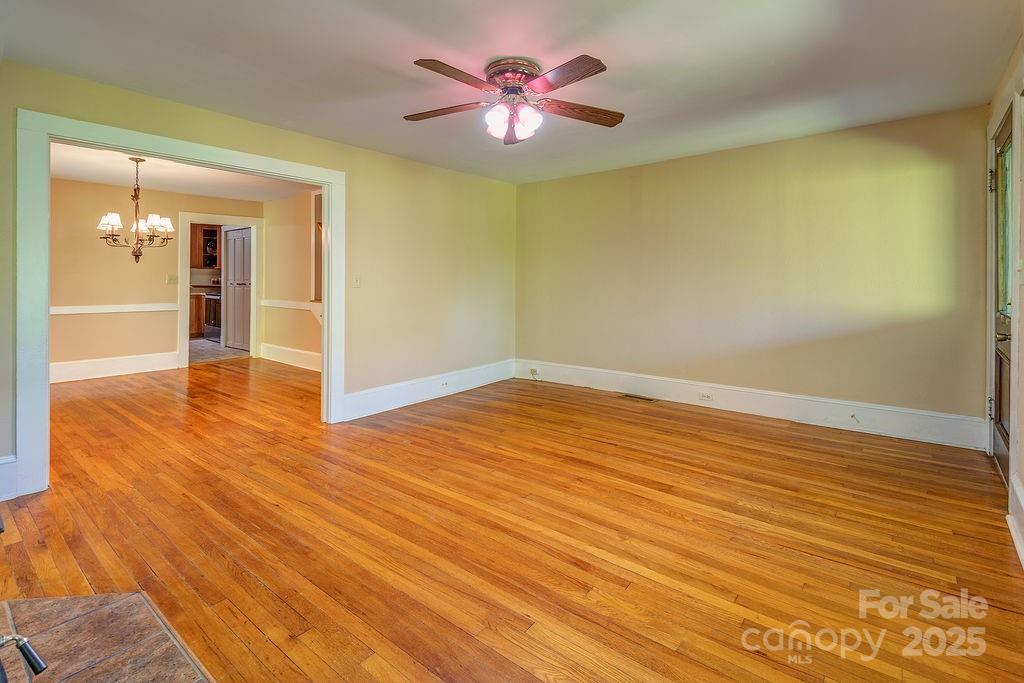 54 Spooks Branch Road Asheville, NC 28804 - Photo 5 of 41 wooden floor in an empty room with a window