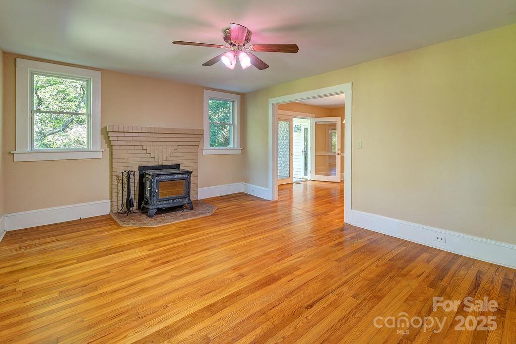 54 Spooks Branch Road Asheville, NC 28804 - Photo 6 of 41 a view of empty room with wooden floor and fan