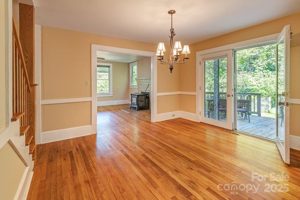 54 Spooks Branch Road Asheville, NC 28804 - Photo 7 of 41 a view of empty room with wooden floor and fan