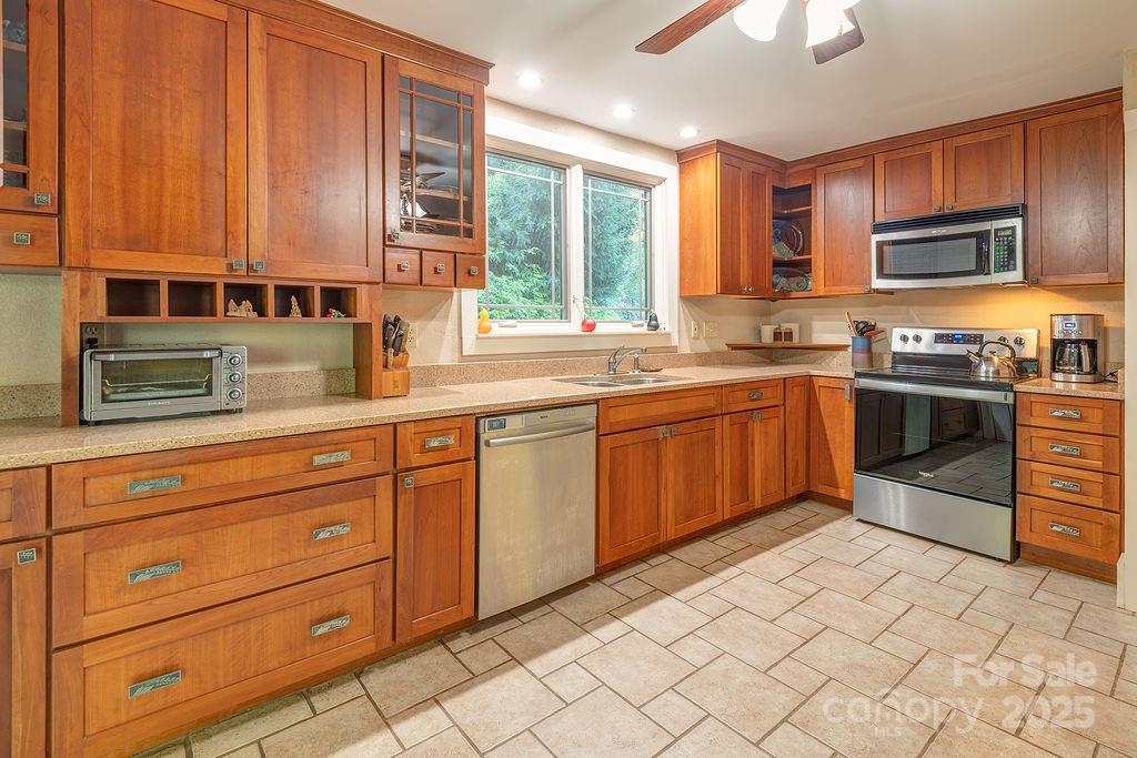 54 Spooks Branch Road Asheville, NC 28804 - Photo 10 of 41 a kitchen with stainless steel appliances granite countertop a sink a stove and cabinets