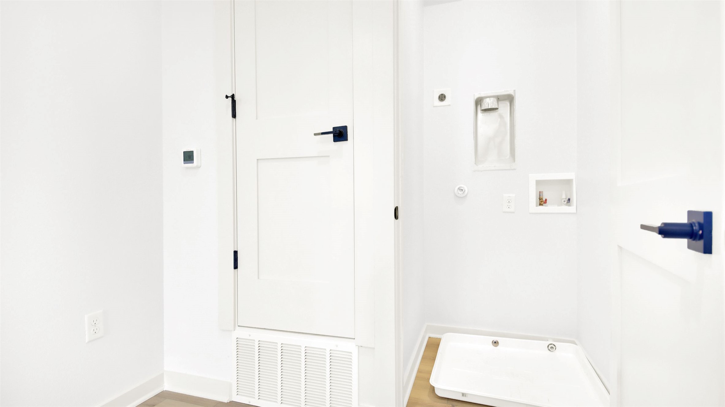 7208 Providence Avenue, Unit 1 Austin, TX 78752 - Photo 14 of 26 This area features light-colored flooring, white walls, and a white door with black hardware