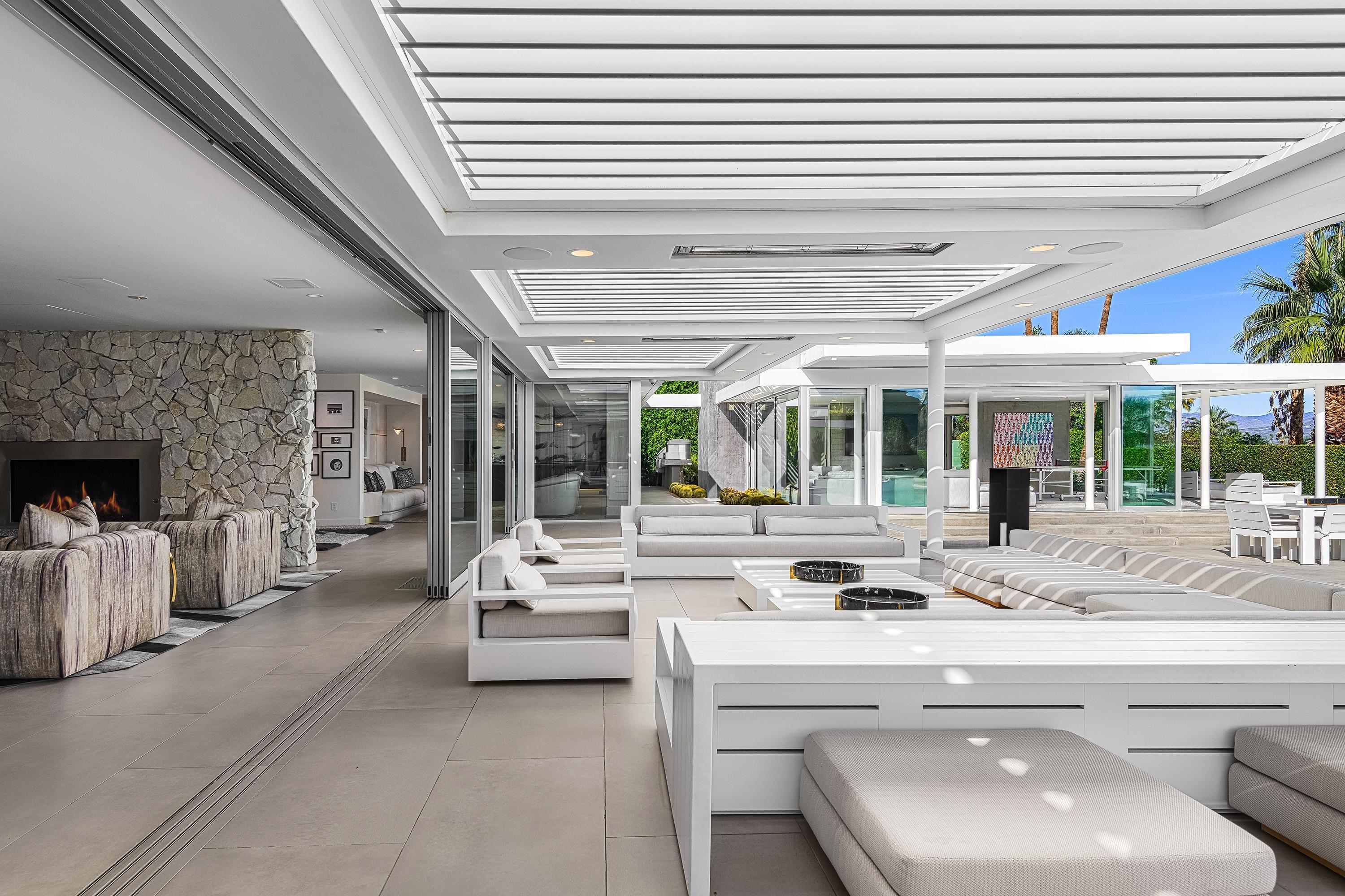 70260 Carson Road Rancho Mirage, CA 92270 - Photo 19 of 80 a living room with fireplace furniture and a large window