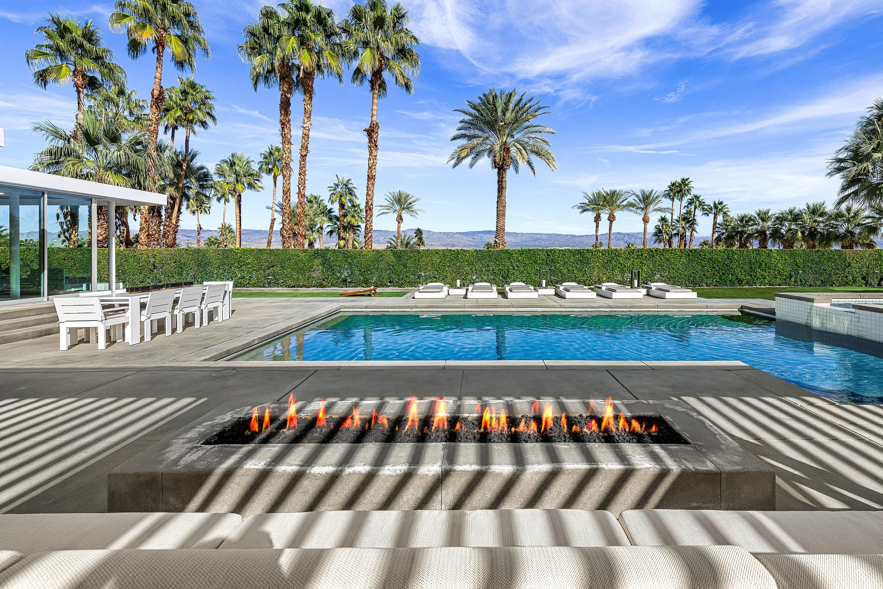 70260 Carson Road Rancho Mirage, CA 92270 - Photo 21 of 80 a view of a swimming pool with a table and chairs