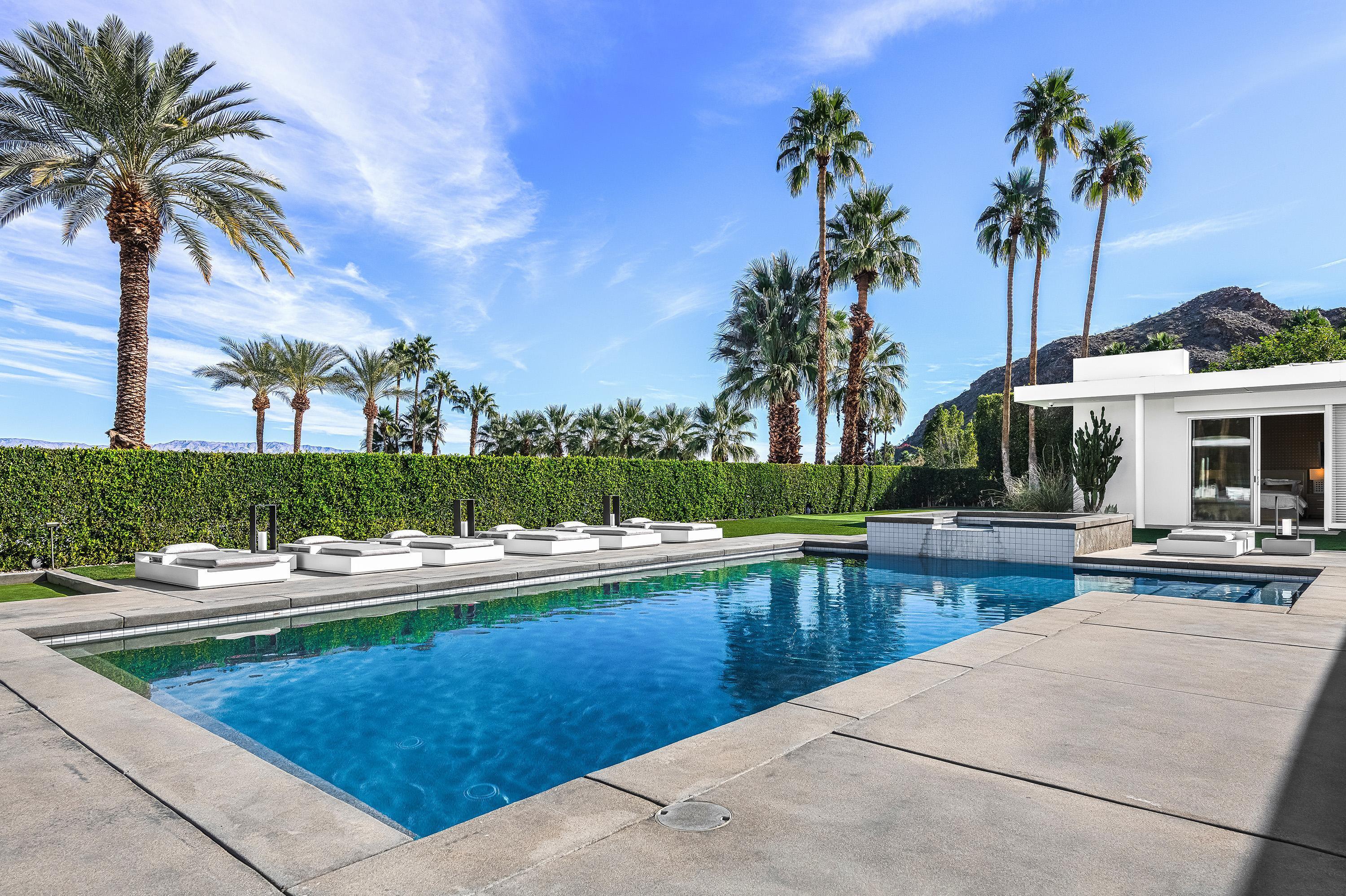 70260 Carson Road Rancho Mirage, CA 92270 - Photo 22 of 80 a view of a house with swimming pool and sitting area