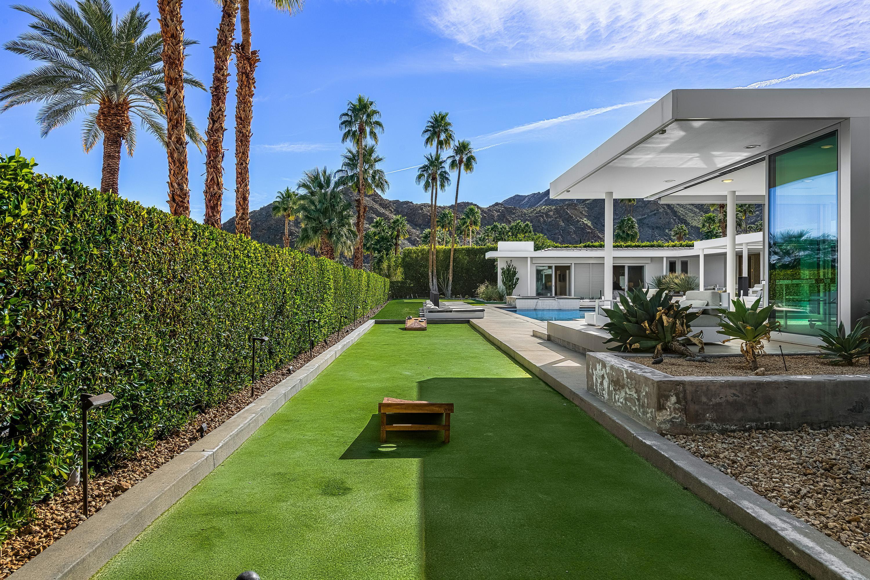 70260 Carson Road Rancho Mirage, CA 92270 - Photo 32 of 80 a view of a backyard with couches under an umbrella