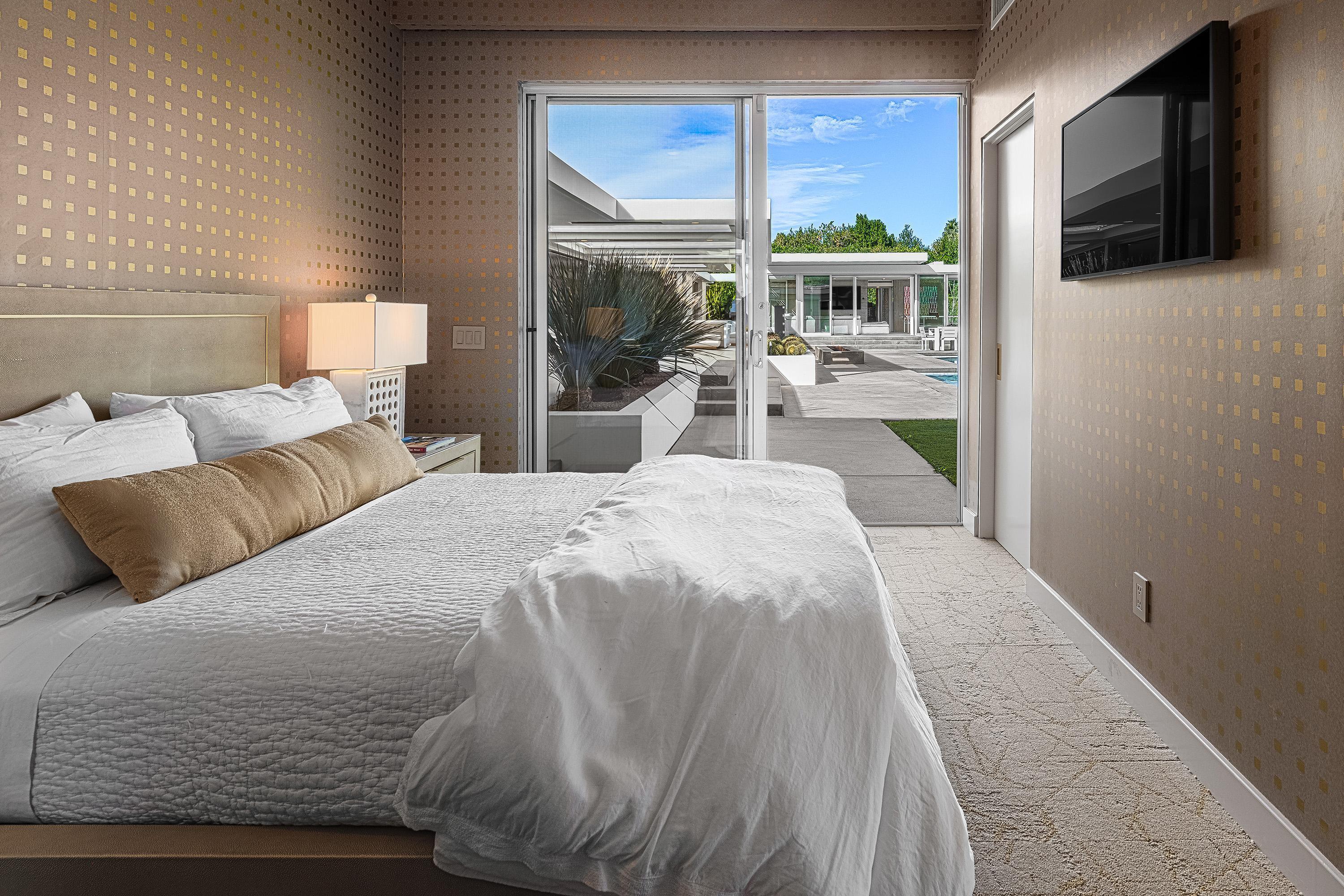 70260 Carson Road Rancho Mirage, CA 92270 - Photo 51 of 80 a bedroom with a large bed and a balcony