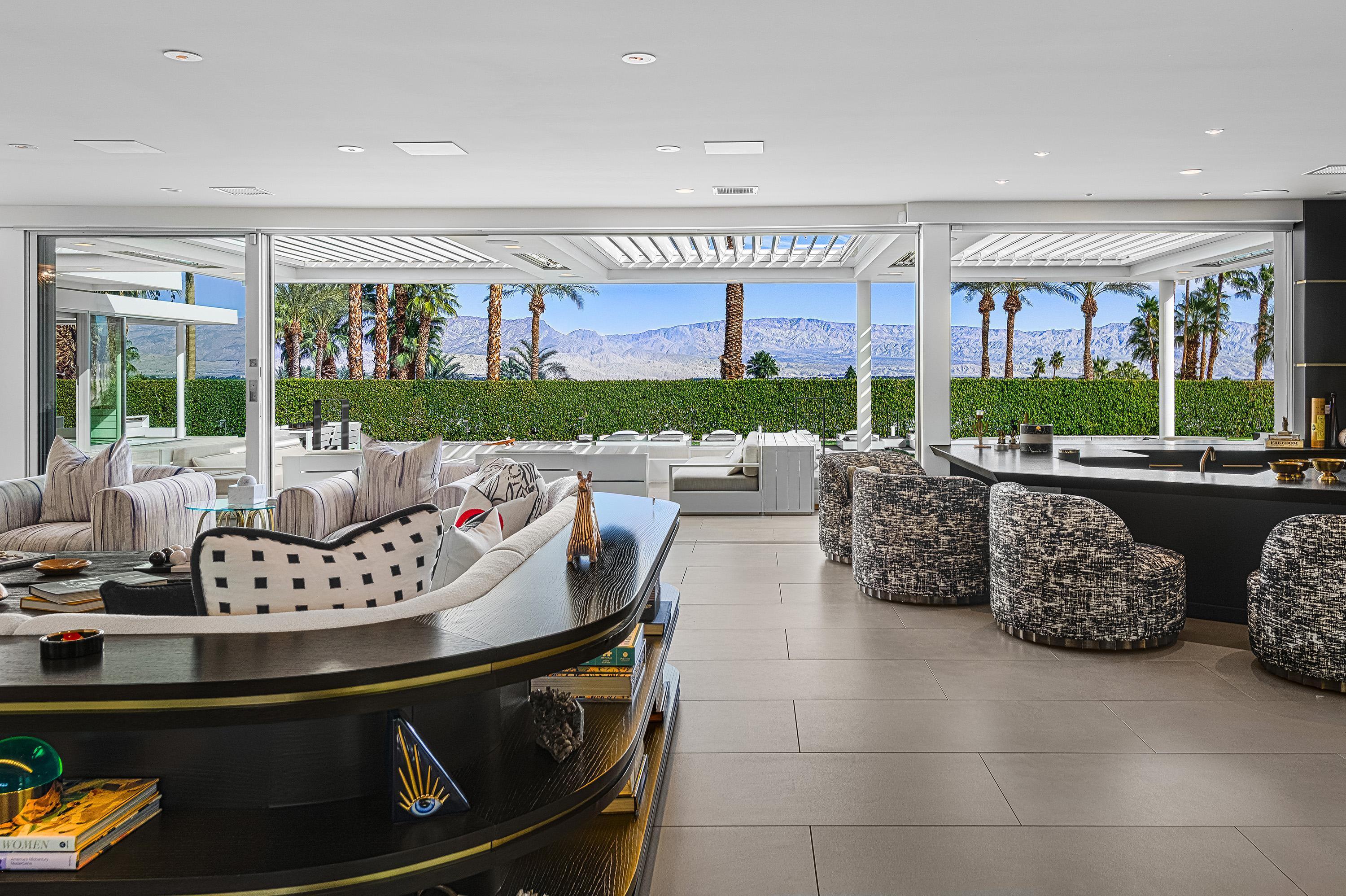 70260 Carson Road Rancho Mirage, CA 92270 - Photo 8 of 80 a living room with furniture and a floor to ceiling window