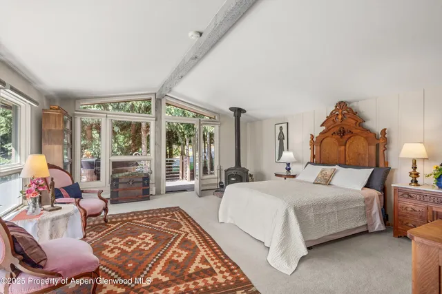 a bedroom with a bed and glass window