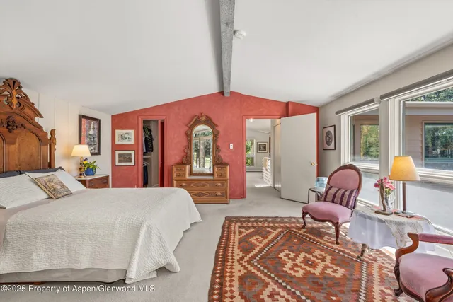 a bedroom with furniture and a window