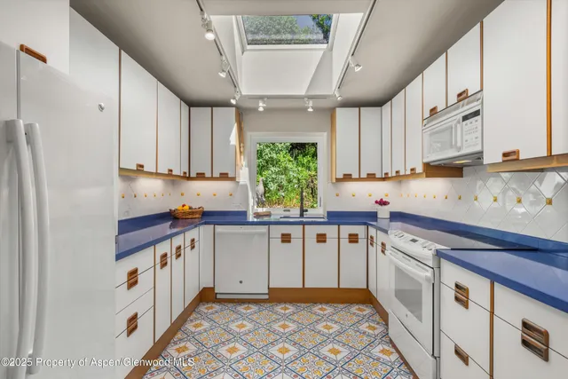 a kitchen with stainless steel appliances granite countertop a sink and cabinets