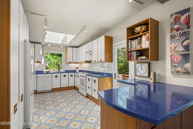 a kitchen with stainless steel appliances granite countertop a sink and cabinets