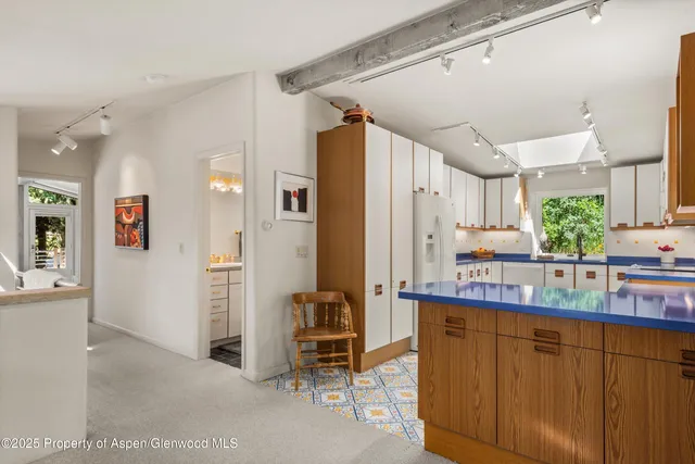 a kitchen with stainless steel appliances a refrigerator and a counter space