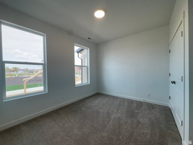1883 West 1575th North, Unit 236 Layton, UT 84041 - Photo 3 of 22 Unfurnished bedroom featuring dark colored carpet and a closet