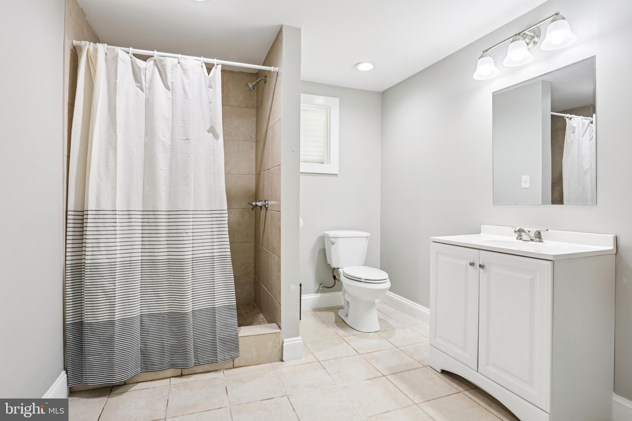 15 Brimfield Road Audubon, PA 19403 - Photo 27 of 41 a bathroom with a sink a toilet and shower