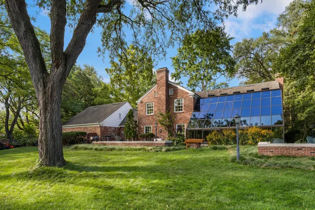 a view of backyard of house with green space