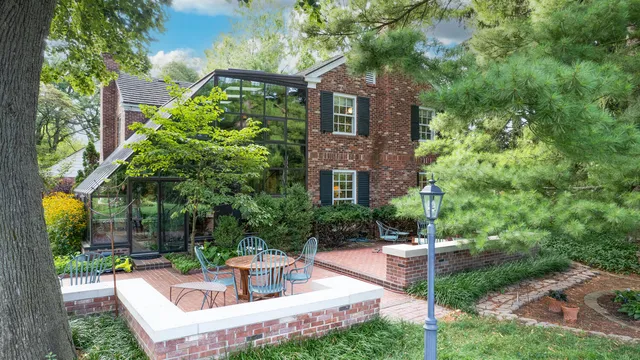 a view of house with a yard and potted plants