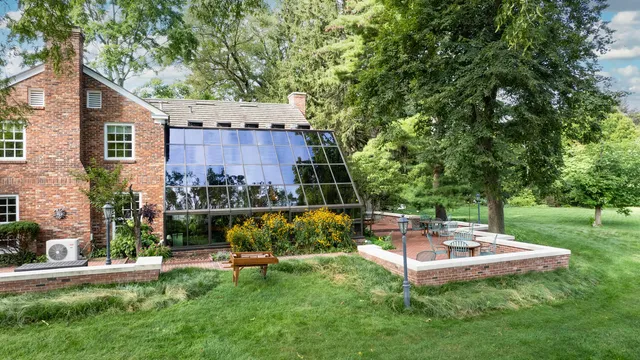 a backyard of a house with a table and chairs