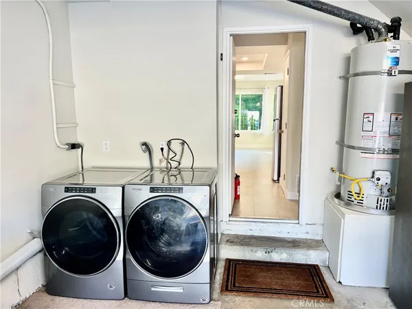 a view of storage and utility room with washer and dryer