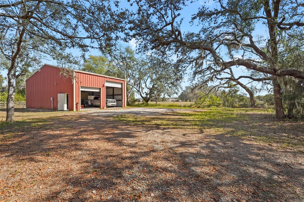 23655 Jennings Road Myakka City, FL 34251 - Photo 16 of 43 a front view of house with yard and trees around