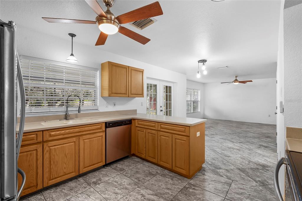 23655 Jennings Road Myakka City, FL 34251 - Photo 31 of 43 a kitchen with stainless steel appliances granite countertop a sink and a refrigerator