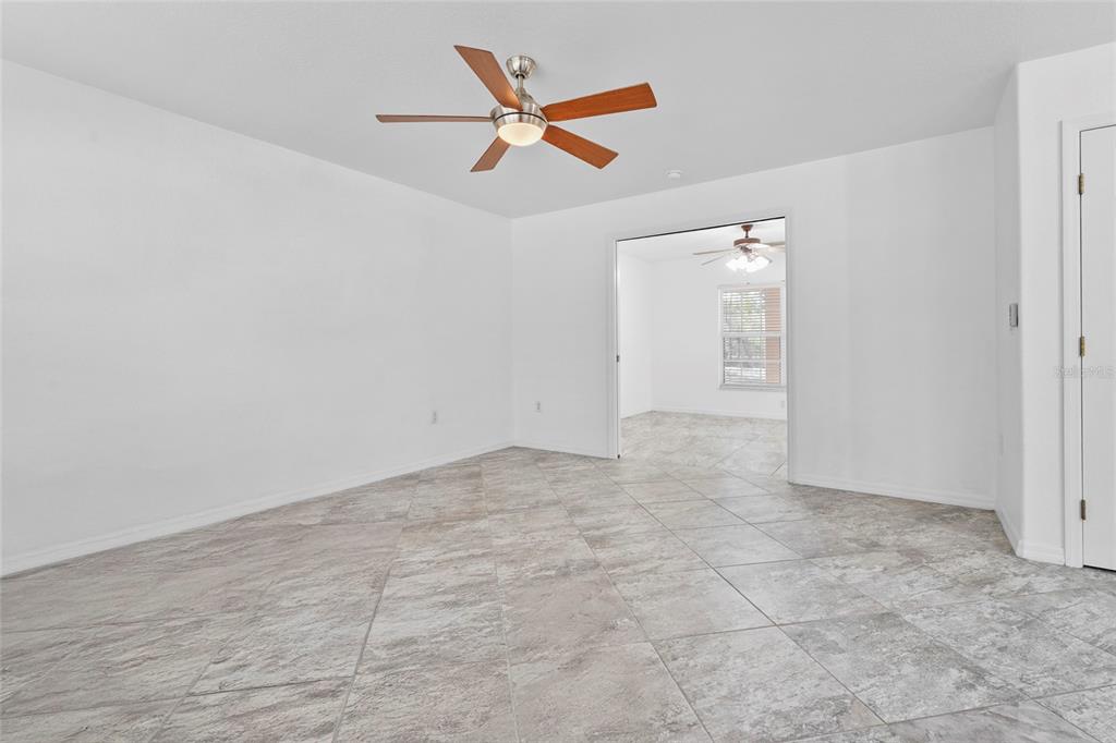 23655 Jennings Road Myakka City, FL 34251 - Photo 33 of 43 an empty room with ceiling fan and window